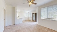 Located in San Diego, CA (92108), this 2-bedroom, 1-bathroom residence offers a well-designed single-floor layout with a bright and airy feel throughout. The open living area is filled with natural light from multiple windows adorned with white blinds, and features warm neutral carpet and a ceiling fan overhead. A glass-paneled entry door adds a welcoming touch to the space.

The kitchen is appointed with light wood cabinetry, striking marble-look quartz countertops, stainless steel appliances including a dishwasher and refrigerator, and light hardwood-style flooring. A breakfast bar connects the kitchen to the living area, enhancing the open-concept flow.

Both bedrooms are carpeted and include ceiling fans, with the primary bedroom offering a walk-in closet equipped with wire shelving for ample storage. Each bedroom benefits from natural light through sizable windows. The bathroom features a full tub/shower combo with white tile surround, a quartz-topped vanity with light wood cabinetry, and hardwood-style flooring. A dedicated in-unit laundry room with washer and dryer hookups adds everyday convenience. Two hallways and two closets complete this functional and well-appointed San Diego residence.