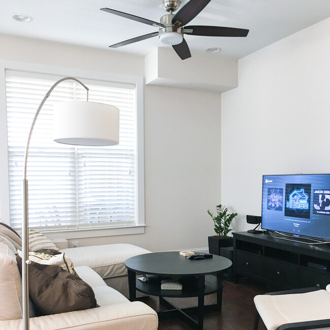 Living room featuring comfy couch with chaise - 700 Finsbury St.