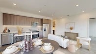 Located at 27972 Forbes Rd in Laguna Niguel, CA, this well-appointed 2-bedroom, 2-bathroom residence offers a thoughtfully designed open-concept layout that maximizes both function and style. Light wood-tone flooring flows throughout, complemented by crisp white walls and recessed lighting that create a bright, modern ambiance.

The kitchen is outfitted with sleek flat-front cabinetry in a warm wood finish, a textured tile backsplash, white quartz countertops, and stainless steel appliances. It opens seamlessly to the dining area and living room, making the space ideal for entertaining. The dining area is anchored by large floor-to-ceiling windows and sliding glass doors that frame outdoor views and flood the space with natural light.

The living room is equally bright, with generous windows overlooking the surrounding landscape. Each bedroom features wood-look flooring, a ceiling fan, and large windows with exterior views, while each includes its own dedicated closet with adjustable shelving systems for ample storage. The bathrooms are finished with marble-style tile flooring, floating vanities with wood-tone cabinetry, and clean modern fixtures. A hallway with smart thermostat integration adds a practical, contemporary touch to this well-designed Laguna Niguel residence.
