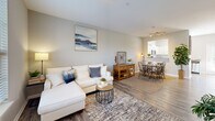 Located at 2 Abbott Drive in Hampton, Virginia, this two-story home offers 3 bedrooms and 3 bathrooms across two well-proportioned floors. The main level features an open-concept living and dining area with wood-look flooring, neutral gray walls, and a large window that fills the space with natural light. The layout flows seamlessly into a well-appointed kitchen equipped with stainless steel appliances, white shaker cabinetry, granite countertops, a subway tile backsplash, and wood-look flooring. A convenient half bathroom with a pedestal sink is also located on the main floor. Upstairs, three carpeted bedrooms offer comfortable retreats, each with large windows that invite ample natural light and outdoor views. The spacious primary bedroom provides a generous footprint with room for a full furniture arrangement. The full bathrooms feature white vanities with granite countertops, large mirrors with lighted fixtures, and wood-look flooring. A dedicated closet adds practical storage. Throughout, the home maintains a cohesive, modern aesthetic with soft neutral tones and clean finishes, creating a warm and inviting atmosphere ideal for everyday living.
