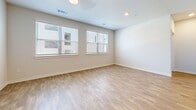 Located in San Antonio, TX, this single-floor 2-bedroom, 2-bathroom residence offers a thoughtfully designed layout that balances comfort and functionality. Warm wood-style flooring flows seamlessly throughout the entire space, lending a cohesive and inviting feel to every room.

The kitchen is a standout, equipped with stainless steel appliances including a french-door refrigerator, range, and microwave. Gray shaker-style cabinetry pairs elegantly with granite countertops, while a central island with a built-in sink adds both workspace and casual dining convenience. Recessed lighting and a subway tile backsplash complete the polished look.

The open living area is filled with natural light from multiple large windows dressed with clean horizontal blinds. A ceiling fan adds comfort, and the neutral wall tones create a versatile backdrop. Both bedrooms are generously proportioned, each featuring large windows that invite natural light and views of surrounding greenery, along with ceiling fans and dedicated closets.

The two full bathrooms are finished with granite-top vanities featuring gray cabinetry, large mirrors, and marble-style tiled tub-and-shower combinations. Wood-style flooring continues into the bathrooms, maintaining design consistency. The overall aesthetic is clean, modern, and move-in ready.