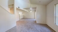 Located at 2505 5th St in Davis, CA, this two-story, 4-bedroom, 5-bathroom home offers a thoughtfully organized layout spread across two floors. The main level features a combined dining and living area filled with natural light from large windows and a sliding glass door that opens to a private outdoor balcony. Plush carpeting runs throughout the living spaces, while light wood-look flooring extends through the kitchen and bathrooms. The kitchen is well-equipped with white cabinetry, light countertops, a full suite of black appliances including a range, microwave, dishwasher, and refrigerator, along with a skylight that adds a bright, airy feel. Each of the four bedrooms is carpeted and features ceiling fans and windows with outdoor views. The primary bedroom connects directly to its own bathroom, which includes white cabinetry and a large vanity mirror. The additional bathrooms are consistently finished with white vanities, wood-look flooring, and tub-shower combinations. Five closets provide ample storage throughout. A dedicated laundry area and multiple hallways connecting both floors via staircases complete this functional and comfortable home.