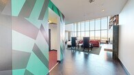 This striking clubhouse in Denver, CO is a masterfully designed social space that blends bold artistic expression with high-end functionality. The single-floor layout is generously proportioned, offering a variety of distinct zones that flow seamlessly from one to the next via a connecting hallway. Soaring double-height ceilings and expansive floor-to-ceiling windows flood the interior with natural light while framing panoramic views of the Denver skyline and surrounding landscape.

The main lounge area is a visual centerpiece, featuring eclectic furnishings in deep pinks, purples, and florals set against dramatic geometric murals in teal and charcoal. A sculptural black bubble coffee table, a curved white sofa, and bold accent chairs create a layered, gallery-like atmosphere. A teal-tiled fireplace surrounded by floor-to-ceiling bookshelves anchors a cozy library lounge, accented by an oversized eye artwork that commands attention.

The kitchen and dining area showcases a terrazzo island, a gold-accented tray ceiling, and a long communal dining table ideal for gatherings, all framed by sweeping outdoor views. Hexagonal tile flooring runs throughout, providing a cohesive design thread. Hanging greenery and sculptural plants add organic warmth to this thoughtfully curated, artistically immersive clubhouse.