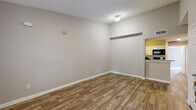 Located at 1325 W Tharpe St in Tallahassee, FL, this unit offers a functional and well-organized single-floor layout with five bedrooms and four full bathrooms. The combined living and dining area features wood-look plank flooring, neutral gray walls, and clean white baseboards, creating a bright and versatile common space. A pass-through opening connects the living area to the kitchen, which is outfitted with white shaker-style cabinetry, granite-look countertops, black appliances including a refrigerator and dishwasher, and matching wood-look flooring for a cohesive aesthetic. The bedrooms offer a mix of finishes, with some featuring soft carpet and others continuing the wood-look flooring. Several bedrooms include mirrored sliding closet doors and windows that bring in natural light. The four bathrooms are consistently appointed with white vanity cabinetry, granite-look countertops, and wood-look tile flooring, providing a clean and modern feel. Multiple closets and hallways throughout the unit contribute to ample storage and easy circulation. A dedicated laundry area adds everyday convenience. The neutral color palette and consistent finishes throughout create a cohesive, move-in ready environment suited for shared or family living.