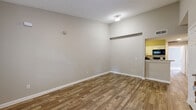 Located at 1325 W Tharpe St in Tallahassee, FL, this unit offers a functional and well-organized single-floor layout with five bedrooms and four full bathrooms. The combined living and dining area features wood-look plank flooring, neutral gray walls, and clean white baseboards, creating a bright and versatile common space. A pass-through opening connects the living area to the kitchen, which is outfitted with white shaker-style cabinetry, granite-look countertops, black appliances including a refrigerator and dishwasher, and matching wood-look flooring for a cohesive aesthetic. The bedrooms offer a mix of finishes, with some featuring soft carpet and others continuing the wood-look flooring. Several bedrooms include mirrored sliding closet doors and windows that bring in natural light. The four bathrooms are consistently appointed with white vanity cabinetry, granite-look countertops, and wood-look tile flooring, providing a clean and modern feel. Multiple closets and hallways throughout the unit contribute to ample storage and easy circulation. A dedicated laundry area adds everyday convenience. The neutral color palette and consistent finishes throughout create a cohesive, move-in ready environment suited for shared or family living.