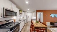 Located at 3000 Shadowood Pkwy SE in Atlanta, GA, this 2-bedroom, 2-bathroom residence offers a thoughtfully designed single-floor layout with a comfortable and modern aesthetic throughout. The open-concept kitchen and living area serves as the heart of the home, featuring a well-equipped kitchen with white shaker cabinets, subway tile backsplash, dark granite countertops, stainless steel appliances including a gas range, microwave, dishwasher, and refrigerator, complemented by wood-look flooring and recessed lighting. The adjoining living room is bright and inviting, with a contemporary geometric chandelier, large sliding glass doors that open to a private balcony with outdoor views, and natural light streaming in. Both bedrooms are carpeted and feature ceiling fans, natural light from large windows, and dedicated closets. The spacious primary bedroom includes soft blue accent walls and a generous closet. The bathrooms are finished with dark granite vanity tops and glass-enclosed showers with white tile surrounds. A dedicated in-unit laundry room adds everyday convenience. With four total closets throughout, storage is plentiful. The overall ambiance is contemporary and welcoming, combining practical function with stylish finishes.