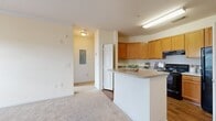 Located at 617 Juniper Ln in Macon, GA, this single-floor, one-bedroom, one-bathroom residence offers a well-organized layout designed to maximize its compact footprint. The interior is organized across a living room, kitchen, bedroom, bathroom, hallway, and two closets, providing efficient use of space throughout.

The kitchen is a functional highlight of the unit, featuring warm honey-toned cabinetry with ample upper and lower storage, light-colored countertops, and a full suite of black appliances including an electric range, dishwasher, and refrigerator. A peninsula with a wraparound countertop adds workspace and visual separation from the adjacent living area. The kitchen floor features hardwood-style flooring, which transitions to plush neutral carpet throughout the living and bedroom areas.

The living room is bright and welcoming, with a glass-paneled exterior door and an additional window that bring in natural light. A ceiling fan overhead adds comfort. The bedroom continues the carpeted flooring and offers a large window with an outdoor view, a ceiling fan, and access to two closets. The bathroom is clean and simply appointed, featuring a full tub-shower combination with a curved curtain rod, wood-style flooring, and neutral wall tones that maintain a cohesive, understated aesthetic throughout the unit.