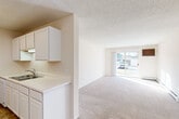 Located at 1402 S Marion Rd in Sioux Falls, South Dakota, this single-floor, three-bedroom, two-bathroom home offers a practical and comfortable layout across a well-utilized footprint. The open-concept kitchen and dining area features white cabinetry, light countertops, a double-basin sink with a dishwasher, and tile flooring — all flowing seamlessly into the adjoining living spaces. A structural column defines the transition between the kitchen and the carpeted living room, which is bright and open with a sliding glass door that invites natural light and provides outdoor access and views. Textured ceilings carry throughout the home, lending a consistent character to each room. The three bedrooms are carpeted and well-proportioned, with the generously sized primary bedroom offering ample space. Bedrooms are equipped with ceiling fans and windows that bring in natural light. The home includes five closets, highlighted by a walk-in closet with built-in wood shelving and hanging rods. Both bathrooms are functional, with one featuring a full tub-shower combo and tile flooring. A dedicated laundry room with tile flooring accommodates a full-size washer and dryer and includes additional overhead shelving. A central hallway connects the private areas of the home efficiently.