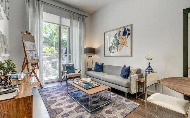 Living Room With Outdoor Patio View Through Sliding Glass Door - Pearl Flagler Village