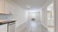 Located at 6022 Buchanan Pl in West New York, NJ, this one-bedroom, one-bathroom unit offers a thoughtfully designed single-floor layout that maximizes every square foot. Light hardwood-style flooring runs throughout, complementing the crisp white walls and clean-lined aesthetic found across every room.

The open living area is bright and welcoming, with a window fitted with blinds that allow natural light to filter in. A wall-mounted PTAC unit provides both heating and cooling comfort. The space flows seamlessly into the kitchen, which features white shaker-style cabinetry on both upper and lower levels, a sleek dark countertop, a subway tile backsplash, stainless steel hardware, and a dishwasher — delivering a polished, functional cooking space.

The bedroom continues the light, airy feel with its own window and PTAC unit, offering a comfortable and private retreat. A dedicated walk-in closet outfitted with wire shelving and hanging rods provides generous storage capacity.

The bathroom is finished to a high standard, with a white vanity offering ample cabinet storage, a white countertop, a well-lit mirror, and tile flooring. The overall design of the unit is clean, modern, and move-in ready, making it an efficient and attractive residence in West New York.