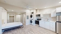 This 430 square foot studio apartment in Bend, Oregon, offers a thoughtful blend of functionality and modern design. The open-concept layout maximizes the use of space, creating a sense of openness despite its compact size. A standout feature is the gas fireplace with a sleek stone surround, providing both warmth and a focal point for the living area.

The kitchen boasts contemporary white cabinetry, stainless steel appliances, and a convenient microwave, ideal for efficient meal preparation. Full-size, stacked washer and dryer units are seamlessly integrated, offering the convenience of in-unit laundry.

Light wood-look flooring unifies the space, complementing the neutral wall tones and contributing to the bright, airy ambiance. Recessed lighting throughout ensures even illumination, while a large window allows natural light to flood the interior.

The bathroom features clean lines with a white vanity and toilet. Two closets provide ample storage solutions. The living area is versatile, with space for both seating and sleeping arrangements, making efficient use of the studio layout.

Overall, this studio apartment combines modern amenities with smart space utilization, creating a comfortable and stylish living environment in a prime Bend location.