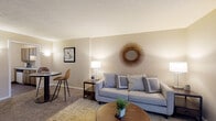 Located at 1700 Bob-O-Link Bnd in Columbus, Ohio, this two-floor residence offers a practical and comfortable layout across two levels. The main floor opens into a carpeted living area bathed in warm, neutral tones, featuring a sliding glass door that leads directly to a private outdoor patio — an ideal space for relaxing or entertaining. A staircase connects the main level to the upper floor, and the open sightlines create a sense of ease throughout the home. The kitchen is efficiently designed with wood-toned cabinetry, light countertops, a double-basin sink, and a window that brings in natural light. Durable wood-style flooring and built-in appliances add to the kitchen's functionality. The bedrooms are carpeted and finished in warm neutral hues. One bedroom offers space for two beds and features framed artwork, while another provides a comfortable single-occupancy retreat with a bright window and outdoor views. A well-appointed bathroom features a marble-patterned countertop, a round undermount sink, and a large mirror. Throughout the home, the design emphasizes clean lines, neutral palettes, and practical living spaces that are both welcoming and easy to maintain.