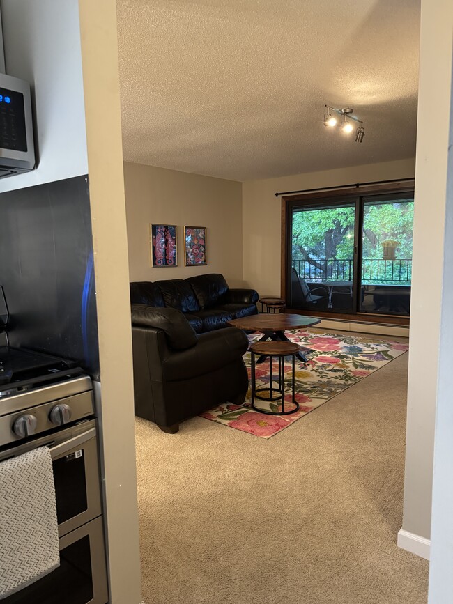Living room with walk out balcony - 7500 Cahill Rd