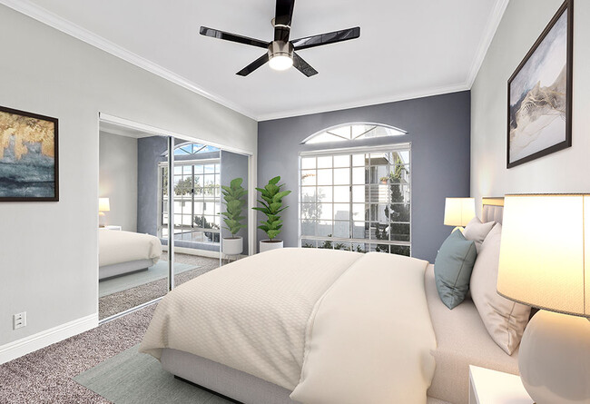 Carpeted bedroom featuring beautiful natural lighting and ceiling fan. - Chateau Encino