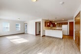 Located at 177 Pump Dr in Burlington, WA, this single-floor, 3-bedroom, 1-bathroom residence offers a well-organized and functional layout. Light wood-style flooring flows consistently throughout the entire space, complementing the clean, neutral-toned walls and creating a bright, cohesive atmosphere.

The open-concept kitchen and living area forms the heart of the home. The kitchen is equipped with warm-toned wood cabinetry, white appliances including a range, over-the-range microwave, refrigerator, and dishwasher, along with light countertops and a peninsula with a built-in sink — ideal for both cooking and casual dining. Pendant lighting above the peninsula adds a polished finishing touch. The adjacent living area benefits from multiple windows that invite generous natural light.

Each of the three bedrooms is bright and comfortable, featuring windows with views of the surrounding greenery and sliding closet doors that provide convenient storage. Each bedroom includes its own dedicated closet, keeping the space organized and functional.

The bathroom is clean and simply appointed, featuring a full tub-shower combination with chrome fixtures. Throughout the unit, recessed lighting, flush-mount ceiling fixtures, and large windows ensure consistently well-lit interiors. This residence offers a practical and inviting layout suited for a variety of lifestyles.