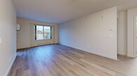 Located at 1588 Spall Rd in Kelowna, BC, this well-appointed two-bedroom, two-bathroom unit offers a functional and comfortable layout across a single floor. Light-toned laminate flooring runs throughout, lending a clean and cohesive look to every room.

The open-concept living, dining, and kitchen area serves as the heart of the unit. The kitchen is fitted with warm wood cabinetry, granite-style countertops, a stainless steel refrigerator, and ample storage, making it both practical and inviting. Multiple windows in the living area allow natural light to fill the space, complemented by a balcony for outdoor access.

The spacious primary bedroom features large windows that bring in generous natural light and offer views of the surrounding neighbourhood, along with a dedicated closet. The second bedroom is equally well-lit with its own window and closet. Both rooms are finished with the same light laminate flooring.

The two bathrooms are distinctly configured: one features a full tub-shower combination with a vanity and large mirror, while the other offers a corner neo-angle glass shower. Both are finished in neutral tones with laminate flooring. Additional highlights include four closets for ample storage and a dedicated in-unit laundry area, rounding out this practical and comfortable Kelowna residence.