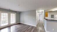 Located at 3825 Hixson Pike in Chattanooga, TN, this single-floor, 3-bedroom, 2-bathroom home offers a well-organized and comfortable layout. Consistent hardwood-style flooring flows throughout, complemented by soft gray walls and crisp white trim, creating a clean and cohesive aesthetic.

The open living area is a standout feature, bathed in natural light through a set of French doors that lead to the exterior. The galley-style kitchen is efficiently designed with light wood cabinetry, dark granite-style countertops, a double-basin stainless steel sink, and white appliances including a range and refrigerator. A breakfast bar provides additional counter space and separation from the living area.

A hallway connects the three bedrooms, each featuring hardwood-style flooring and windows that bring in natural light. The primary bedroom is generously sized with access to a dedicated bathroom equipped with a dual-sink vanity with dark countertops, wood cabinetry, and a tub-shower combination. The second bathroom mirrors the same design finishes. A closet with double doors provides ample storage in the primary suite. The home's straightforward, functional layout makes it an ideal space in the heart of Chattanooga.