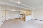Located at 3483 Larimore Ave in Omaha, Nebraska, this 1-bedroom, 1-bathroom unit offers a thoughtfully organized floor plan that maximizes its comfortable footprint. The open-concept living area seamlessly integrates the living room, dining space, and kitchen into one cohesive zone, creating an airy and functional environment. Soft neutral carpet flows throughout the main living and bedroom areas, while the kitchen transitions to smooth hard-surface flooring.

The kitchen is outfitted with white cabinetry, white appliances including a range, microwave, and refrigerator, and features a peninsula counter with a sink and pendant lighting above — an ideal spot for casual dining or meal prep. Recessed lighting illuminates the main living area, complemented by a stylish globe pendant light over the kitchen peninsula.

The bedroom is a quiet, well-proportioned retreat featuring plush carpet, a sleek ceiling fan with integrated lighting, and a dedicated closet. Natural light enters through multiple windows, lending a bright and open feel to the space.

A full bathroom and additional closet complete the layout. Throughout the unit, clean white walls, modern fixtures, and a cohesive neutral palette create a fresh, move-in-ready atmosphere well-suited for comfortable everyday living.