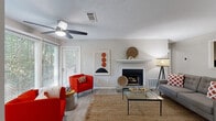 Located in Duluth, GA, this well-appointed 2-bedroom, 2-bathroom single-floor residence offers a thoughtfully designed layout across a comfortable footprint. The living room serves as the heart of the home, featuring wood-look flooring, a ceiling fan, a classic fireplace with a white mantel, and large windows that invite abundant natural light and views of lush greenery outside. The space flows seamlessly into a dedicated dining area, accented by chair rail molding and a textured ceiling. The galley-style kitchen is outfitted with dark cabinetry, white countertops, a subway tile backsplash, and black appliances, with direct access to the in-unit laundry area housing a full-size washer and dryer. The primary bedroom features plush carpeting and a spacious closet with built-in shelving, while the second bedroom offers similar comfort with a window overlooking the outdoors. Both bathrooms are finished in neutral tones, with one featuring a tub-shower combination and wood-look vinyl flooring. A dedicated closet and laundry room round out the functional layout, making this a complete and practical living space.