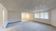 Located at 14260 SW 112th Ave in Tigard, Oregon, this single-floor unit offers four bedrooms, one full bathroom, and two closets across a well-utilized layout. The interior is finished consistently throughout, featuring plush wall-to-wall carpeting, neutral cream-toned walls, and textured popcorn ceilings that carry through each room.

The spacious primary bedroom is a standout feature, offering generous room dimensions with multiple windows dressed in vertical blinds that allow ample natural light to fill the space. The remaining three bedrooms are comfortably sized, each with carpeted floors, textured ceilings, and individual windows providing outdoor views and natural light. Wall-mounted heating units are present in several rooms, ensuring functional climate control.

The full bathroom is efficiently designed, featuring a tub and shower combination, a toilet, and a single-sink vanity with warm wood cabinetry and a light countertop. The hallway connecting the rooms provides a logical and practical flow throughout the unit.

Overall, the unit presents a clean, straightforward layout with consistent finishes, making it a functional and practical living space suited for a variety of occupants in a residential Tigard neighborhood.