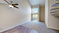 Located at 2380 Sierra Blvd in Sacramento, CA, this two-story, 3-bedroom, 4-bathroom home offers a well-designed layout across two floors. The main level provides the larger share of the living space and features an open living area with soaring vaulted ceilings, abundant natural light from oversized windows, and sliding glass doors that open to the outdoors. A distinctive white spiral staircase serves as a central architectural focal point, connecting the two levels with both style and efficiency. The kitchen is outfitted with white cabinetry, light quartz countertops, stainless steel appliances including a range, microwave, refrigerator, and dishwasher, all set on warm wood-style flooring. A ceiling fan enhances airflow in the main living area. The three bedrooms are bright and well-proportioned, with carpeted or wood-style flooring, neutral wall tones, and windows offering garden views. The primary bedroom includes a walk-in closet with built-in shelving. The four bathrooms are clean and functional, each featuring tub-shower combinations and wood-style flooring. Two dedicated closets provide additional storage. The upper floor offers a more intimate, versatile space ideal for additional bedrooms or a private retreat.