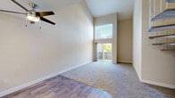 Located at 2380 Sierra Blvd in Sacramento, CA, this two-story, 3-bedroom, 4-bathroom home offers a well-designed layout across two floors. The main level provides the larger share of the living space and features an open living area with soaring vaulted ceilings, abundant natural light from oversized windows, and sliding glass doors that open to the outdoors. A distinctive white spiral staircase serves as a central architectural focal point, connecting the two levels with both style and efficiency. The kitchen is outfitted with white cabinetry, light quartz countertops, stainless steel appliances including a range, microwave, refrigerator, and dishwasher, all set on warm wood-style flooring. A ceiling fan enhances airflow in the main living area. The three bedrooms are bright and well-proportioned, with carpeted or wood-style flooring, neutral wall tones, and windows offering garden views. The primary bedroom includes a walk-in closet with built-in shelving. The four bathrooms are clean and functional, each featuring tub-shower combinations and wood-style flooring. Two dedicated closets provide additional storage. The upper floor offers a more intimate, versatile space ideal for additional bedrooms or a private retreat.