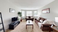 Located at 420 Riverglade Dr in Amherst, MA, this single-floor residence offers 1 bedroom, 2 bathrooms, a dedicated office, and a thoughtfully designed layout that maximizes comfort and functionality. The open-concept living and dining area features neutral-toned carpet, a pendant light above the dining space, and windows that invite natural light. The kitchen is equipped with warm-toned wood cabinetry, black appliances including a range and refrigerator, generous counter space, and a peninsula breakfast bar with barstool seating — seamlessly connecting to the dining area. The spacious primary bedroom features carpeted flooring, a window with natural light, and ample room for a full bedroom suite. A versatile office provides a quiet, carpeted workspace with a window overlooking the outdoors, ideal for remote work or study. Two bathrooms include a full bath and a half bath, both finished with warm wood vanities, neutral tile flooring, and clean, functional fixtures. A closet provides dedicated storage. Throughout the residence, a consistent neutral color palette and soft carpeting create a calm, cohesive aesthetic. The layout flows naturally between rooms, offering a balanced combination of private and shared living spaces in a well-maintained Amherst community.