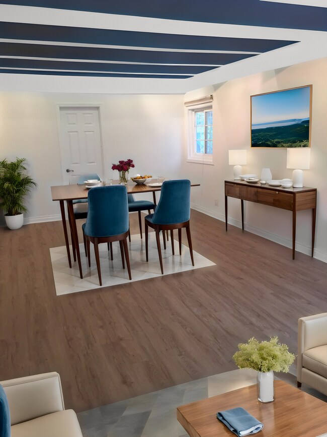staged photo of dining area near kitchen with bedroom door on back wall - 1372 Neola St