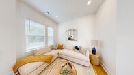 Located at 4705 Goose Creek in Charlotte, NC, this three-story home offers 3 bedrooms and 4 bathrooms thoughtfully distributed across three well-proportioned floors. Light wood flooring runs throughout, complementing the crisp white walls and recessed lighting that give every room a clean, modern feel.

The main level hosts an open-concept living, dining, and kitchen area filled with natural light from large windows with wood blinds. The kitchen features white shaker cabinetry, stainless steel appliances, a center island with pendant lighting, and light countertops. The dining area flows seamlessly into a cozy sitting nook, while the living room showcases a neutral sectional sofa and an arched decorative mirror as a focal point.

The upper floors accommodate the bedrooms, including a spacious primary suite, each room benefiting from natural light and clean architectural lines. Closets provide ample storage throughout. The four bathrooms are finished with marble-look tile flooring, gray vanities with white countertops, and subway tile surrounds in the showers and tub areas.

A central staircase connects all three levels, creating a natural flow through the home. With its consistent modern palette, abundant natural light, and efficient use of space across each floor, this Charlotte home delivers a bright and functional living environment.