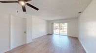 Located in Winter Park, Florida, this single-floor residence offers 2 bedrooms and 3 bathrooms within a thoughtfully laid-out floor plan. Light-toned wood-look flooring runs throughout the home, creating a cohesive and easy-to-maintain interior.

The living room is bright and open, benefiting from abundant natural light streaming through a large sliding glass door that leads to a private balcony overlooking the surrounding landscape. A ceiling fan adds comfort to the space, while textured ceilings are consistent throughout the home.

The galley-style kitchen features warm wood cabinetry lining both walls, light countertops, a double-basin sink, and white appliances including a range, dishwasher, and refrigerator. A pass-through layout connects the kitchen directly to the living area.

Both bedrooms are well-proportioned and filled with natural light from exterior-facing windows. The primary bedroom offers a generous footprint, while the second bedroom provides a comfortable and versatile space. Each room features the same wood-look flooring and a clean, neutral palette.

The three bathrooms are finished in white with tub-shower combinations and wood-toned vanity cabinetry. A hallway and dedicated closet provide practical storage and circulation throughout the home.