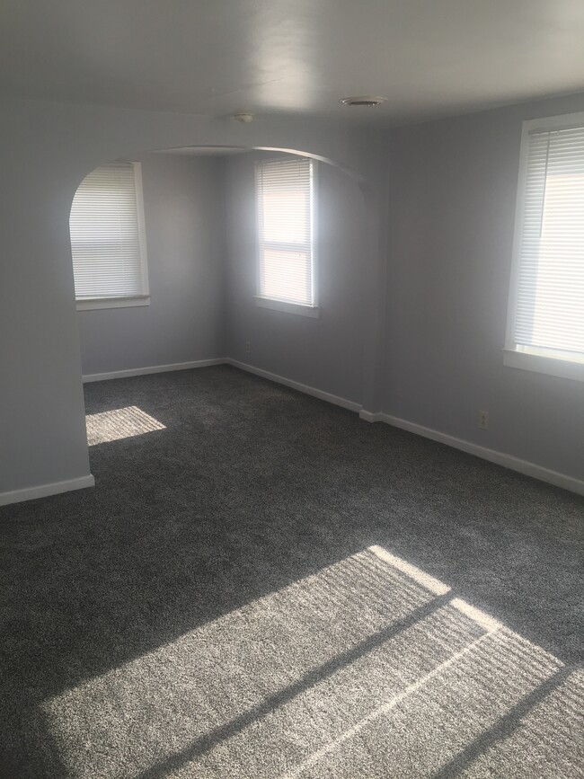 Carpet throughout creates a cozy environment in the living area and bedroom. - 3364 Church St