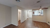 Located at 601 Broadway Commons in Garland, TX, this two-story residence offers a practical and comfortable layout across two levels. The main living area features durable wood-look flooring that extends throughout the open floor plan, creating a cohesive and easy-to-maintain space. A pass-through opening connects the living area to the kitchen, which is outfitted with rich, warm-toned cabinetry, granite-style countertops, and a full suite of appliances including an electric range. Ample upper and lower cabinet storage ensures generous functionality for everyday use. The bedrooms are finished with plush carpeting and equipped with ceiling fans for year-round comfort. Natural light enters through windows fitted with blinds, and closets with built-in shelving provide well-organized storage. Multiple bathrooms throughout the home are appointed consistently with vessel sinks, granite-topped vanities set in rich wood cabinetry, and framed mirrors, offering a polished and cohesive aesthetic. Textured ceilings are present throughout, adding a classic touch to the interiors. The two-floor layout provides a natural separation between living and private spaces, making this a well-structured and functional home in the heart of Garland, Texas.