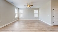 Located at 1104 Spring Path in Nashville, TN, this two-story home offers four bedrooms and four bathrooms across a well-designed layout. The main floor hosts an open-concept kitchen and living area, where the kitchen stands out with gray shaker cabinets, white quartz countertops, stainless steel appliances, pendant lighting, and warm wood-look flooring that flows throughout the home. The living room is bright and airy, featuring multiple windows with natural light and a ceiling fan. An attached garage with an automatic opener provides convenient access. The upper floor is home to the generously sized primary bedroom, featuring vaulted ceilings and a ceiling fan, accompanied by an en-suite bathroom with a glass-enclosed walk-in shower, white vanity, and wood-look flooring. A walk-in closet with wire shelving and ample storage completes the suite. Three additional bedrooms, including one with vaulted ceilings and a window view, offer versatile space. A dedicated laundry room with washer and dryer hookups and overhead shelving adds everyday convenience. Three hallways connect the home's spaces efficiently, and the neutral color palette and clean finishes throughout give the home a fresh, move-in-ready feel.