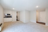 Located at 530 N Civic Dr in Walnut Creek, CA, this well-appointed 2-bedroom, 1-bathroom residence offers a functional and comfortable single-floor layout. The combined kitchen and living room serves as the heart of the home, featuring recessed lighting, plush carpeting, and a sliding glass door that opens to an outdoor patio, filling the space with natural light and providing a seamless indoor-outdoor connection. The kitchen is efficiently designed with wood-look flooring, white cabinetry, dark granite-style countertops, and stainless steel appliances including a full-size refrigerator, range, and microwave. Both bedrooms are carpeted and bathed in natural light from sliding or standard windows with views of lush greenery. The primary bedroom features mirrored sliding closet doors and a ceiling fan, while the second bedroom includes a baseboard heater beneath its window. A hallway connects the living areas to the bedrooms and the full bathroom, which is appointed with wood-look flooring, a granite-topped vanity, and a tub/shower combination enclosed with sleek sliding glass doors. A dedicated closet provides additional storage, completing this neatly organized and move-in ready home.
