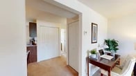 Located at 202 Grenadier Dr in Liverpool, NY, this single-floor residence offers three bedrooms, one bathroom, and a thoughtfully organized layout that makes efficient use of its space. The interior features neutral-toned walls and wall-to-wall carpeting throughout the living and bedroom areas, creating a warm, cohesive atmosphere.

The living room is a bright, welcoming space anchored by large windows with vertical blinds that let in generous natural light and offer views of the surrounding greenery. The galley-style kitchen is well-equipped with dark wood cabinetry, stone-patterned countertops, a stainless steel sink, an electric range, and a dishwasher. A window and exterior door provide added ventilation and natural light.

The generously sized primary bedroom features a ceiling fan, a window with outdoor views, and ample room for furniture. The additional bedrooms are comparably comfortable, each with ceiling fans and windows. Two closets provide practical storage throughout the unit. A central hallway connects the rooms and includes additional closet space.

The full bathroom is finished with tiled floors and walls, a tub-shower combination, and a window for natural light. A private balcony off the unit overlooks a well-maintained lawn and mature trees, offering a pleasant outdoor retreat with peaceful suburban views.