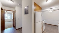 Located at 3817 Macalaster Dr NE in St. Anthony, Minnesota, this one-bedroom, one-bathroom unit offers a functional and well-organized single-floor layout. The living room is bright and open, featuring durable hardwood-style flooring, a baseboard heating system, a wall-mounted air conditioning unit, and a sliding glass door that leads to a private balcony with outdoor views — an ideal space for relaxing or entertaining.

The galley-style kitchen is efficiently designed with warm oak cabinetry providing ample upper and lower storage, a double-basin sink, a white electric range, dishwasher, and refrigerator. The kitchen flows seamlessly into the living area, making the overall space feel connected and practical.

The bedroom is a comfortable size, finished with plush carpeting, a ceiling fan with light fixture, a generously sized closet with louvered bifold doors, and a window that brings in natural light and exterior views. Baseboard heating ensures year-round comfort.

The bathroom features a full tub-shower combination with classic white tile surround, mosaic tile flooring, and a vanity with wood cabinetry. Textured ceilings are present throughout the unit, adding to the space's character. Overall, the unit offers a clean, practical layout well-suited for everyday living.