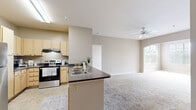 Located at 500 Bristol Village Drive in Midlothian, Virginia, this single-floor, 2-bedroom, 2-bathroom residence offers a well-organized and comfortable layout. The kitchen is equipped with light wood cabinetry, stainless steel appliances including a refrigerator and range, dark laminate countertops, and tile flooring. A peninsula with a built-in sink opens toward the living area, creating a connected, functional space. The living room features plush carpeting and a ceiling fan, with a distinctive arched entryway framing large windows that flood the room with natural light and offer views of surrounding greenery. Both bedrooms are carpeted and well-lit, each with multiple windows dressed with blinds. The primary bedroom is generously sized, while the second bedroom also offers ample space and bright corner windows. Each bathroom is finished with tile flooring and light wood vanities. The primary bathroom includes a soaking tub and access to a walk-in closet, while the second bathroom features a tub-shower combination with a curtain enclosure. Track lighting in the hallway and ceiling fans in key rooms add practical comfort throughout this neatly designed residence.