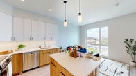 Located on the 7th floor at 1201 Callowhill Street in Philadelphia's vibrant Callowhill neighborhood, this thoughtfully designed one-bedroom, one-bathroom residence makes efficient use of its compact footprint. Light wood-tone flooring runs throughout, creating a warm, cohesive aesthetic that connects each area seamlessly.

The kitchen is a standout feature, showcasing a two-tone design with crisp white upper cabinetry and natural wood lower cabinets, white quartz countertops, a classic subway tile backsplash, and stainless steel appliances. A central island with seating provides both additional prep space and a casual dining option, while pendant lighting adds a polished finishing touch.

The open living area flows naturally from the kitchen, offering a flexible layout bathed in natural light. The bedroom is a serene retreat, featuring large windows that invite abundant daylight and views of the surrounding cityscape, along with light-toned walls that enhance the sense of space.

The bathroom is finished with clean, modern materials, including a floating wood vanity with an illuminated mirror, large-format tile in the walk-in shower, and light wood flooring that ties back to the rest of the unit. Every detail reflects a contemporary design sensibility, making this a well-appointed urban residence in the heart of Philadelphia.