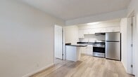 This 510 square foot apartment in Oklahoma City offers a practical living space with a thoughtful layout. The property features two bedrooms and two bathrooms, making it suitable for small families or roommates. The primary bedroom measures 110 square feet, providing a comfortable personal space.

Throughout the apartment, wood-look flooring adds warmth and durability. Large windows in each room allow natural light to filter in, brightening the space. Window-mounted air conditioning units provide climate control for comfort in Oklahoma's varied weather.

The modern kitchen is a highlight, featuring sleek white cabinetry, stainless steel appliances, and a convenient breakfast bar. Dark countertops contrast nicely with the light cabinetry, creating a contemporary aesthetic. The kitchen's open design flows seamlessly into the living area, enhancing the sense of space.

Both bathrooms are efficiently designed with white fixtures and tiled surrounds in the shower/tub combinations. The apartment also includes two closets for storage. Despite its compact size, the thoughtful layout ensures each area feels distinct and functional.

Located at 1200 S Meridian Ave, this single-story apartment offers urban living with easy access to city amenities. The efficient use of space and modern finishes make this property an attractive option for those seeking a contemporary living space in Oklahoma City.