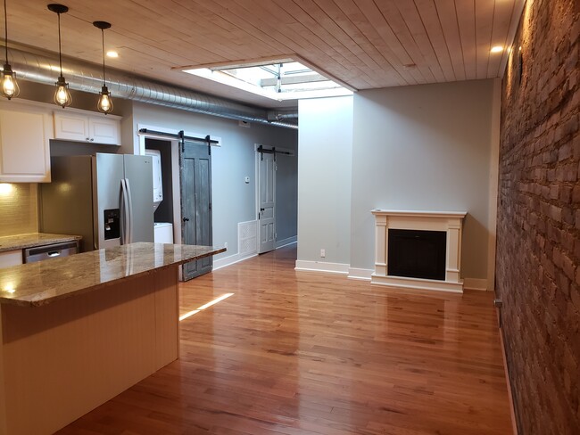 granite countertops with open floorplan and tons of natural light from skylight - 116 S Saginaw St