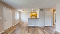 Located at 7701 Sharon Dr in Mentor-on-the-Lake, Ohio, this single-floor unit offers a practical and well-organized layout designed for comfortable everyday living. The open-concept living and dining area is finished with durable wood-look vinyl plank flooring and features a ceiling fan, recessed lighting, and a textured ceiling throughout. Vertical blinds on the windows allow for adjustable natural light, contributing to a bright and airy atmosphere.

The kitchen is accessible via a peninsular breakfast bar with a granite-style countertop, creating a natural division between the living space and the cooking area. Light wood cabinetry provides generous storage, while black appliances — including a refrigerator, electric range, built-in microwave, and a stainless sink — equip the kitchen fully for everyday use.

The bedrooms are carpeted for comfort and each includes a ceiling fan and natural light from windows with blinds. At least one bedroom features a mirrored sliding-door closet, offering convenient storage and a sense of added depth. The full bathroom is finished with tile flooring, warm-toned tile wainscoting, a granite-top vanity, and a full-size tub and shower combo, rounding out the functional and cohesive design of this well-maintained unit.
