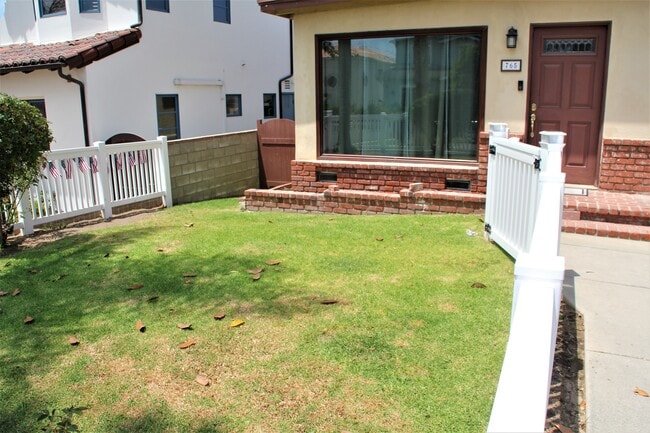 Fenced front yard. - 765 Avenue A