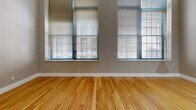 This well-appointed apartment in Lawrence, MA, offers a harmonious blend of comfort and style across its 1,130 square feet. The space boasts two bedrooms, including a primary bedroom of 180 square feet, and two full bathrooms. The open-concept living area seamlessly integrates with the kitchen, creating an inviting atmosphere for both relaxation and entertainment.

The kitchen is a standout feature, equipped with stainless steel appliances, granite countertops, and ample wooden cabinetry. Modern track lighting and a sleek design add to its contemporary appeal. Both bathrooms are tastefully finished with granite vanities and large mirrors, while one bathroom includes a combination tub and shower with built-in shelving.

Throughout the apartment, gleaming hardwood floors provide a warm, elegant foundation. High ceilings and large windows allow natural light to flood the rooms, enhancing the sense of spaciousness. The bedrooms offer generous closet space with white paneled doors, ensuring ample storage.

The apartment's neutral color palette creates a versatile canvas for various decorating styles. Baseboard heating and central air conditioning provide year-round comfort. This thoughtfully designed space combines functionality with aesthetic appeal, offering a desirable urban living experience in a convenient location.