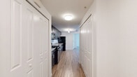 Located at 501 Hartsell Ave in Lakeland, Florida, this single-floor, three-bedroom, two-bathroom home offers a practical and well-appointed layout. Throughout the home, light wood-look flooring provides a clean, cohesive aesthetic that enhances the bright, open feel of the space.

The kitchen is fully equipped with black appliances including a gas range, dishwasher, and refrigerator, complemented by dark cabinetry, granite-style countertops, and a track lighting fixture overhead. A hallway connects the kitchen area to the rest of the home, offering convenient access to all rooms.

Each of the three bedrooms features large windows dressed with vertical blinds, allowing ample natural light and views of the surrounding greenery. Ceiling fans are present in the bedrooms, contributing to year-round comfort. The primary bedroom includes a built-in closet with bifold doors, providing practical storage solutions.

The two bathrooms are finished with tile flooring and granite-topped vanities with dark cabinetry. One bathroom features a full tub-shower combination with floor-to-ceiling tile surround, while both bathrooms are equipped with well-lit vanity mirrors. The overall ambiance of the home is clean, bright, and move-in ready, making it a functional residence in the heart of Lakeland.