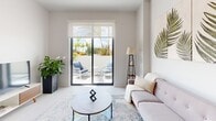 Located in Palmetto Bay, Florida, this contemporary third-floor residence at 18300 SW 98th Ave offers a well-appointed single-level layout with modern finishes throughout. The open-concept living area is bright and airy, featuring light-toned flooring, clean white walls, and large sliding glass doors that lead to a private outdoor terrace, flooding the interior with natural light and offering views of lush tropical surroundings.

The kitchen is designed for both function and style, showcasing warm wood-grain cabinetry, white countertops, and a full suite of stainless steel appliances including a side-by-side refrigerator, dishwasher, range, and over-the-range microwave. A dedicated dining area sits adjacent to the kitchen, creating a seamless flow for everyday living.

The bedrooms are generously sized with recessed lighting, neutral tones, and windows that frame outdoor views. One room also serves well as a home office, complete with a built-in closet. The primary bathroom features a sleek glass-enclosed walk-in shower, wood-grain vanity, and crisp white surfaces. A secondary bathroom offers a tub-shower combination with a modern vanity. The overall ambiance is clean, contemporary, and thoughtfully designed for comfortable South Florida living.