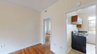Located at 804 W Morgan St in Raleigh, NC, this one-bedroom, one-bathroom unit offers a well-organized, efficient layout across a single floor. Warm hardwood flooring runs throughout the living areas and bedroom, complemented by crisp white crown molding and neutral walls that create a clean, cohesive aesthetic.

The living room is a bright, open space anchored by a large multi-pane window that frames lush greenery, filling the room with natural light and outdoor views. The bedroom continues this theme with an identical style window offering the same verdant outlook, along with a dedicated closet for storage. Additional closets are accessible throughout the unit, providing generous storage solutions rarely found in similarly sized spaces.

The kitchen is thoughtfully appointed with warm wood cabinetry, dark granite countertops, tile flooring, a stainless steel refrigerator, and a window that overlooks the surrounding neighborhood. It offers practical counter and cabinet space suited for everyday cooking.

The bathroom retains a classic character with cream subway-style tiles accented by a bold dark border, a combined tub and shower fixture, and a window that brings in natural light. Throughout the unit, details such as crown molding, well-maintained hardwood floors, and abundant closet space speak to a home that balances charm with functionality.