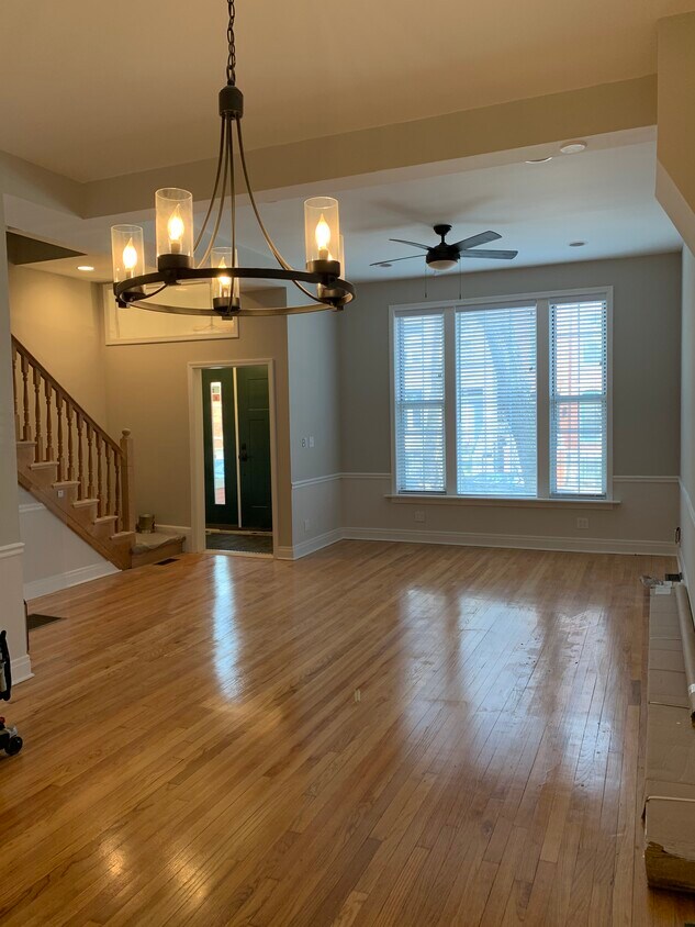 Open and bright living room/dining room with custom blinds and contemporary light fixtures. - 1648 N Claremont Ave