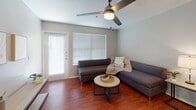 Located at The Exchange on Luther Street in College Station, Texas, this single-floor unit offers a functional and comfortable layout designed to accommodate modern living. The living area features warm wood-look flooring, a ceiling fan, and windows fitted with blinds that allow natural light to fill the space, creating a bright and welcoming atmosphere.

The kitchen is well-equipped with stainless steel appliances, including a range, over-the-range microwave, and a full-size refrigerator. White cabinetry lines the walls, providing ample storage, while light wood-look flooring adds warmth to the space.

Each bedroom features plush carpet flooring, a ceiling fan, and large windows that bring in natural light. Sliding mirrored closet doors with built-in shelving offer generous storage in every room, and a dedicated desk area in each bedroom makes the space well-suited for academic use.

The bathrooms are finished with wood-look flooring, white cabinetry, and well-lit vanity mirrors. Each bathroom includes overhead cabinet storage and a shower-tub combination, maintaining a clean and practical design throughout. The unit's neutral color palette and consistent finishes create a cohesive and comfortable living environment.