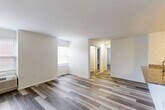 Located at 2215 Arch Street in Philadelphia's vibrant Logan Square neighborhood, this well-appointed one-bedroom, one-bathroom unit offers a thoughtfully designed layout across a single floor. Hardwood-style plank flooring runs throughout, lending warmth and cohesion to every room.

The open combined living and dining area is generously sized, featuring multiple windows with natural light and a wall-unit HVAC system. The space flows naturally into the kitchen, which is outfitted with white shaker cabinetry, granite countertops, a subway tile backsplash extending to the ceiling, and a full suite of stainless steel appliances including a range, microwave, and refrigerator. A peninsula with a built-in sink adds additional prep and counter space.

The bedroom offers a comfortable footprint and is notably equipped with two mirrored sliding-door closets, providing ample storage. A dedicated laundry area and additional closet space add further convenience.

The bathroom is finished with large-format tile flooring, subway tile surrounding the soaking tub and shower, a granite-topped vanity with gray cabinetry, and polished chrome fixtures. A wide vanity mirror completes the clean, modern aesthetic throughout this move-in-ready Philadelphia residence.