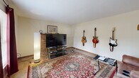 Located at 9001A Creekside Ln in Knoxville, Tennessee, this two-story, two-bedroom, three-bathroom home offers a functional and comfortable layout spread across two well-proportioned floors. The main level features a welcoming living room with light wood-style flooring, a textured ceiling, and a classic brick fireplace that serves as a natural focal point. A staircase connects both floors, adding to the home's open, accessible feel. The galley-style kitchen is efficiently designed with warm honey-toned wood cabinetry lining both sides, white countertops, and a full suite of appliances including a dishwasher, electric range, and refrigerator. Light wood flooring continues throughout, and a sliding glass door brings in natural light and provides outdoor access. The bathrooms are clean and functional, with one featuring a full soaking tub and shower combination with wood-look flooring. The two bedrooms are carpeted for comfort. The spacious primary bedroom is a standout, boasting direct access to a private balcony through a sliding glass door that frames lovely outdoor views of the surrounding greenery. The second bedroom is equally comfortable with plush carpeting and ample space. This home offers practical, well-organized living in a convenient Knoxville location.